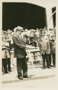 Image of Commander Peary on the deck of the Roosevelt - reading last mail before departure